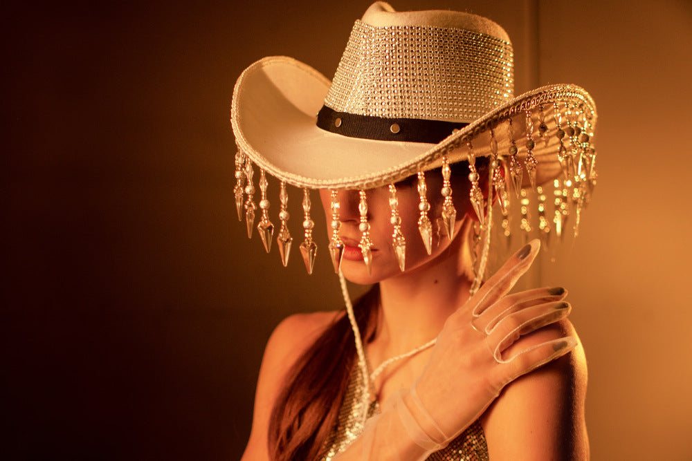 Close photo of a woman wearing a cowboy hat with some disco elements