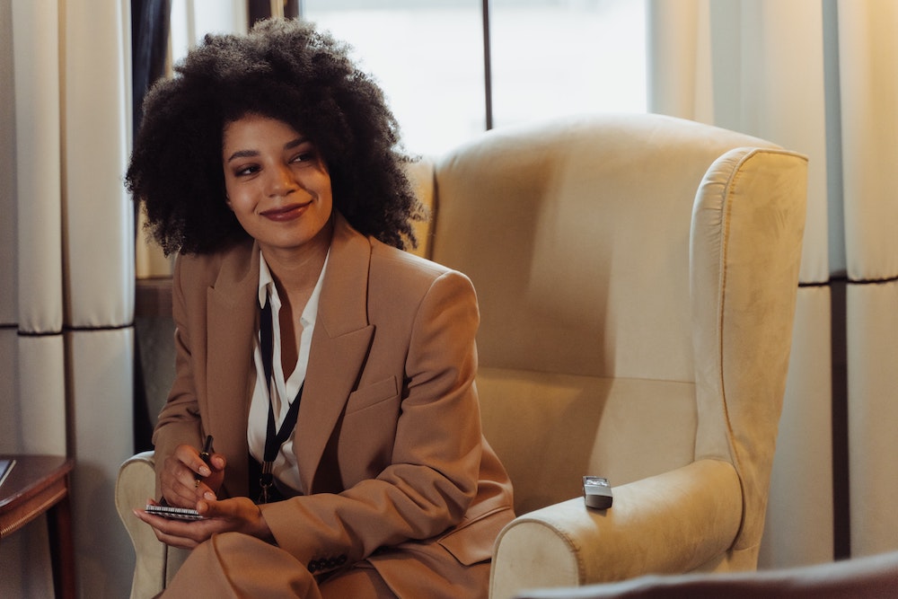 journalist on chair with notepad